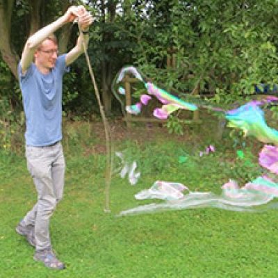 Man making giant bubbles
