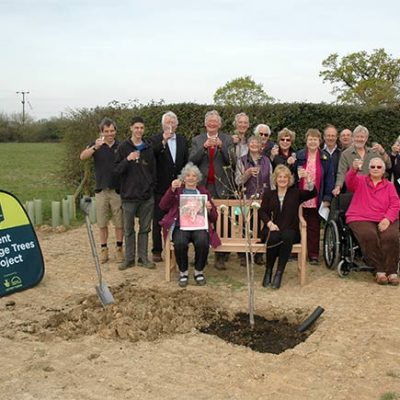 People celebrating the planting of a future heritage tree