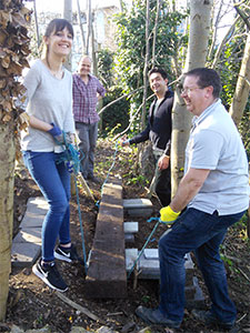 Volunteers lifting a sleeper into place