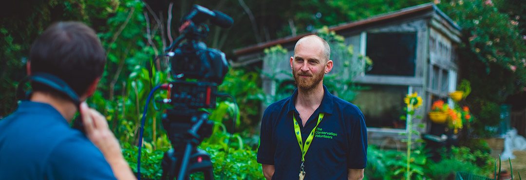 Man standing in front of a video camera