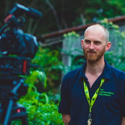 Man standing in front of a video camera