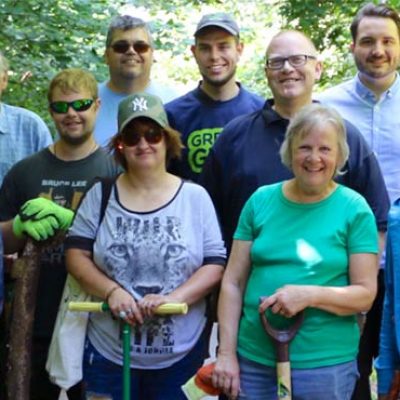 People standing in an outdoor greenspace