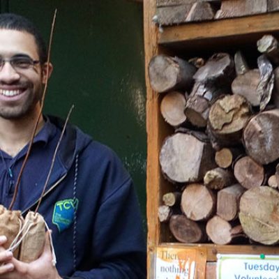 Man holding a young tree sapling