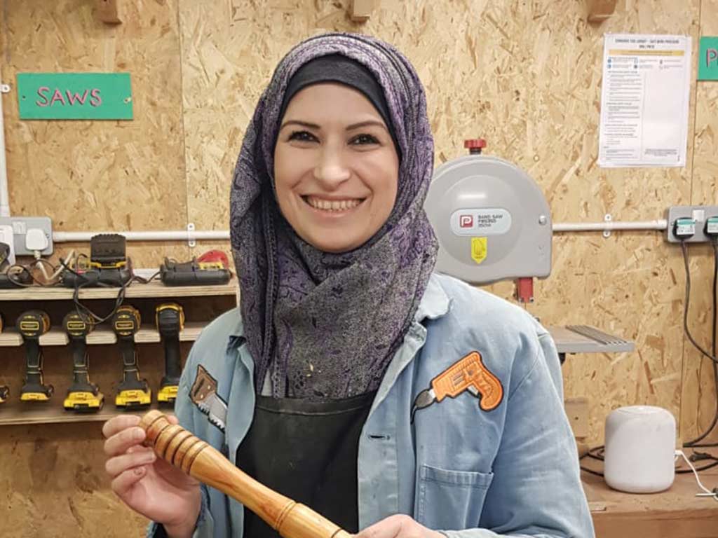 Volunteer holding some lathe work