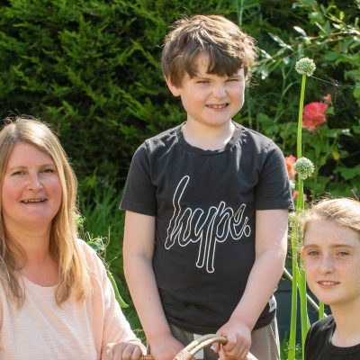 TCV volunteer Hayley with her children and their homegrown produce