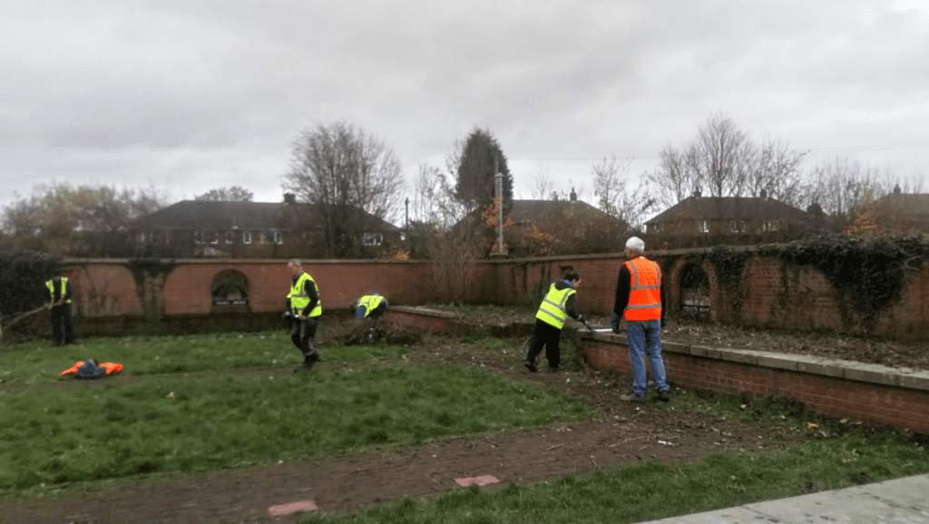 Volunteers spread out clearing some land