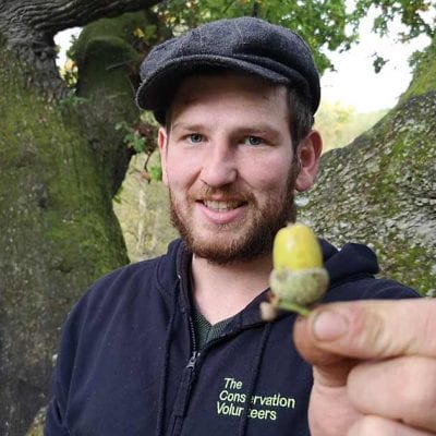 A member of TCV's nursery team with an acorn