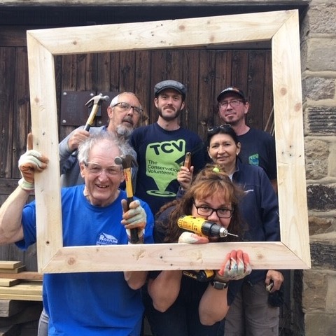 Group of volunteers inside a picture frame