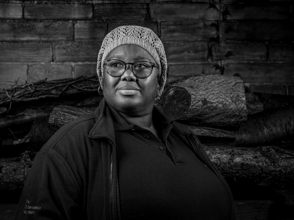 Black and white portrait image of a black lady wearing a hat. Credit Mark Slater, TCV