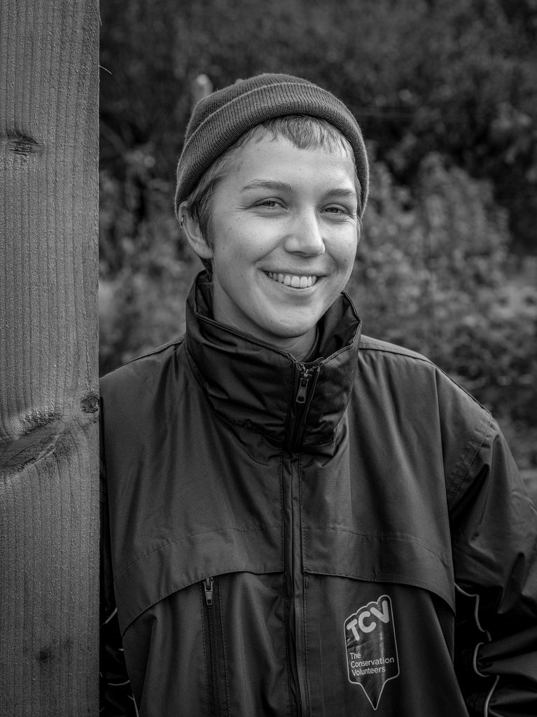 Black and white portrait image of a person wearing a beanie hat. Credit Mark Slater, TCV