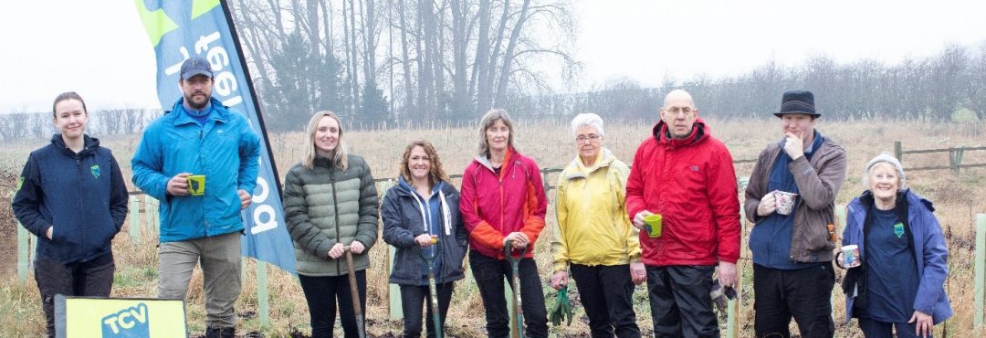 Centre: Sue Paver with Volunteers from Pavers Head Office, and The Conservation Volunteers facing the camera, some with cups of tea in their hands, in a grassy area.