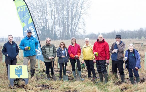 Centre: Sue Paver with Volunteers from Pavers Head Office, and The Conservation Volunteers facing the camera, some with cups of tea in their hands, in a grassy area.