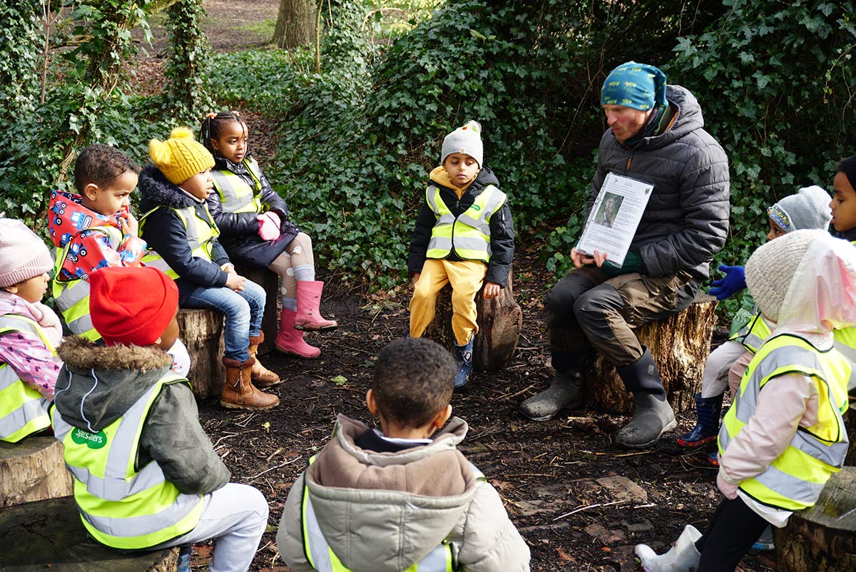 Children sitting outside learning about nature