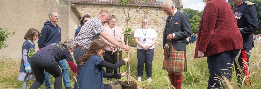 King Charles III plants a tree with TCV volunteers at Kinneil House and Estate.