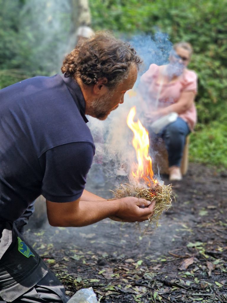 Man with lit kindling