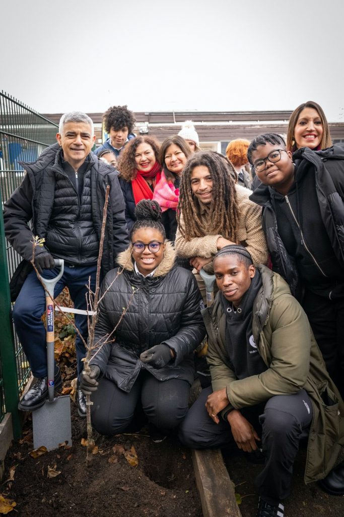 A group of school children with Kedar Williams-Stirling, Sadiq Khan, Tayshan Hayden-Smith and Shirley Rodrigues after planting a tree.