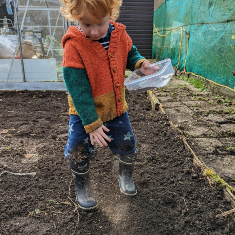 child sowing seeds