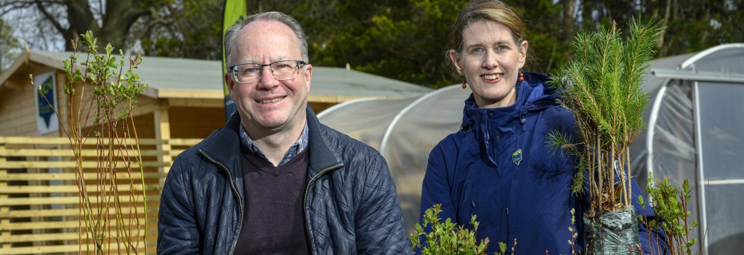 Rebecca Kennelly and Michael Duncan holding tree saplings