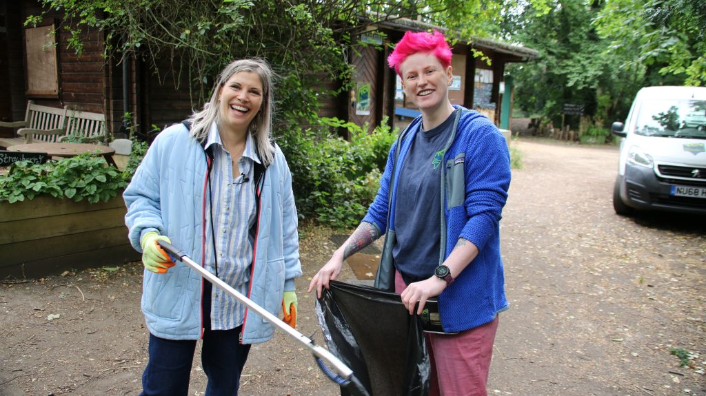 Two females litter picking at a community hub nature reserve