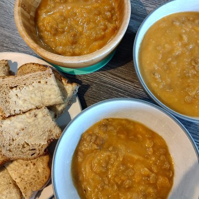 3 bowls of vegetable soup and a plate of cut op bread