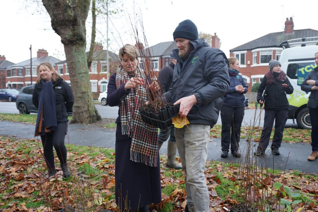 Emma Hardy Visits TCV - holding tree whips 
