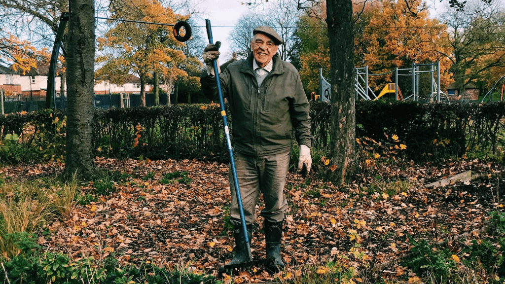A TCV volunteer carrying out light gardening tasks in autumn